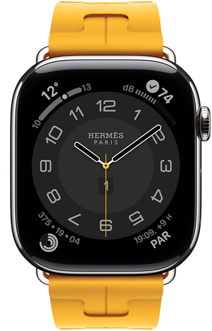 Apple Watch Hermès Series 11, cadran Circulaire (aiguilles des heures, des minutes et des secondes, logo Hermès Paris, complications : Météo, anneaux Activité, heure de Paris et Indice UV), boîtier en titane, argent, côté droit, Digital Crown, associée au bracelet Simple Tour Kilim, jaune (jaune canari), caoutchouc fluoroélastomère