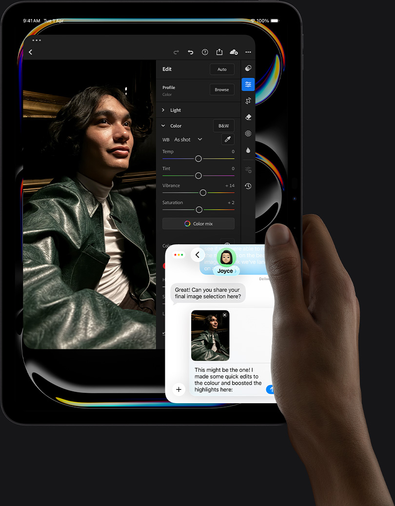 iPad Pro, front exterior, portrait orientation, space black colour, right hand holding device, display showing photo editing app with image of a person in a leather jacket, editing tools and sliders,  iMessage conversation happening between user and another individual reviewing the photo