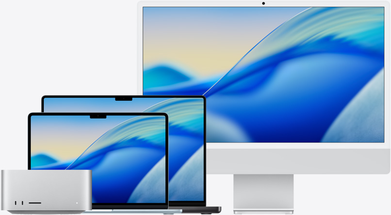 De macOS Tahoe-achtergrond op verschillende modellen uit de Mac-productlijn, met van links naar rechts: Mac Studio, 13-inch MacBook Air in Hemelsblauw, 14-inch MacBook Pro in Spacezwart en 24‑inch iMac in Zilver